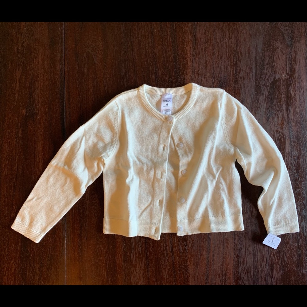 Little girl’s white sweater